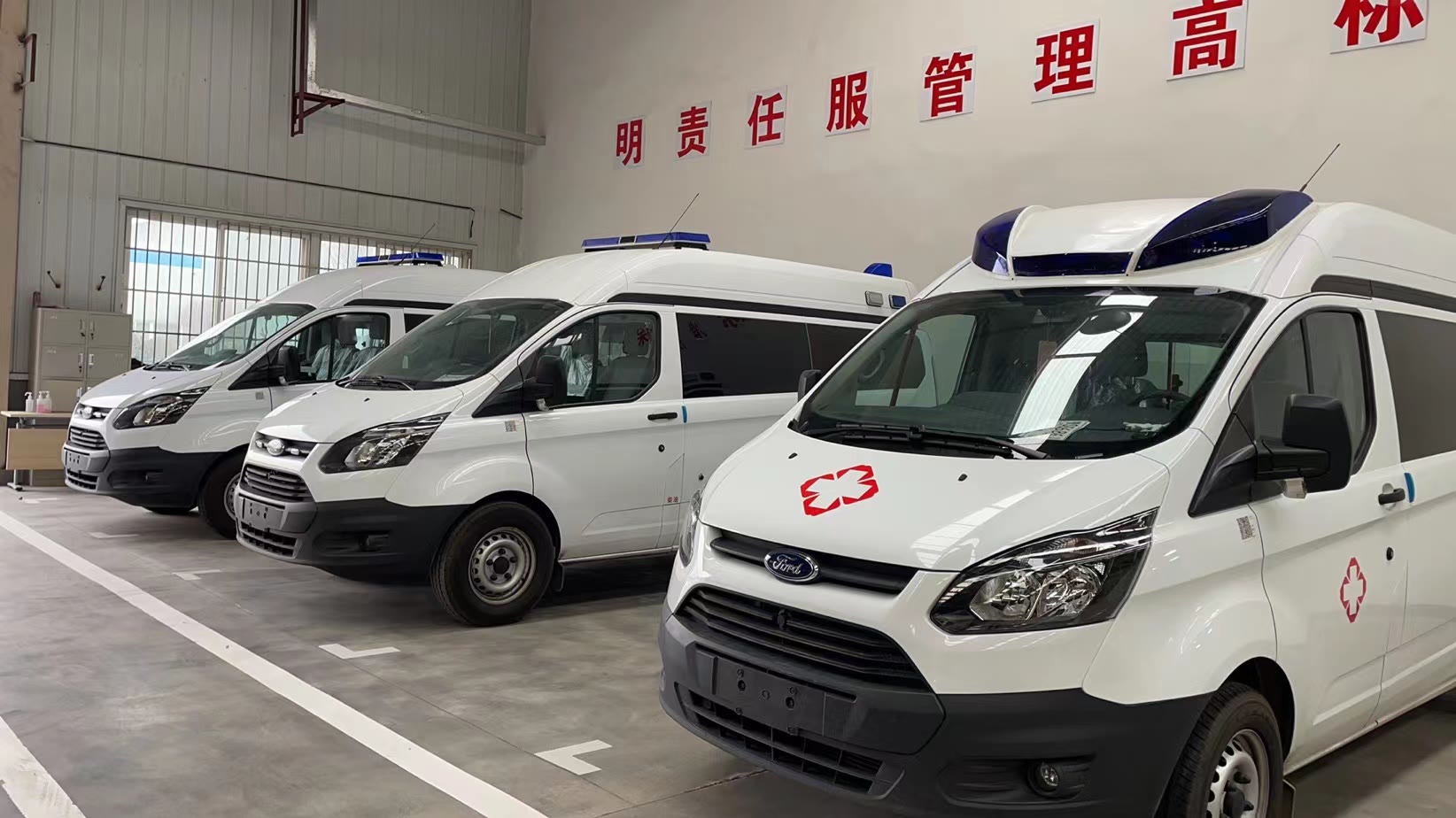 Completed ambulance vehicles lined up inside the SZ AUTO workshop